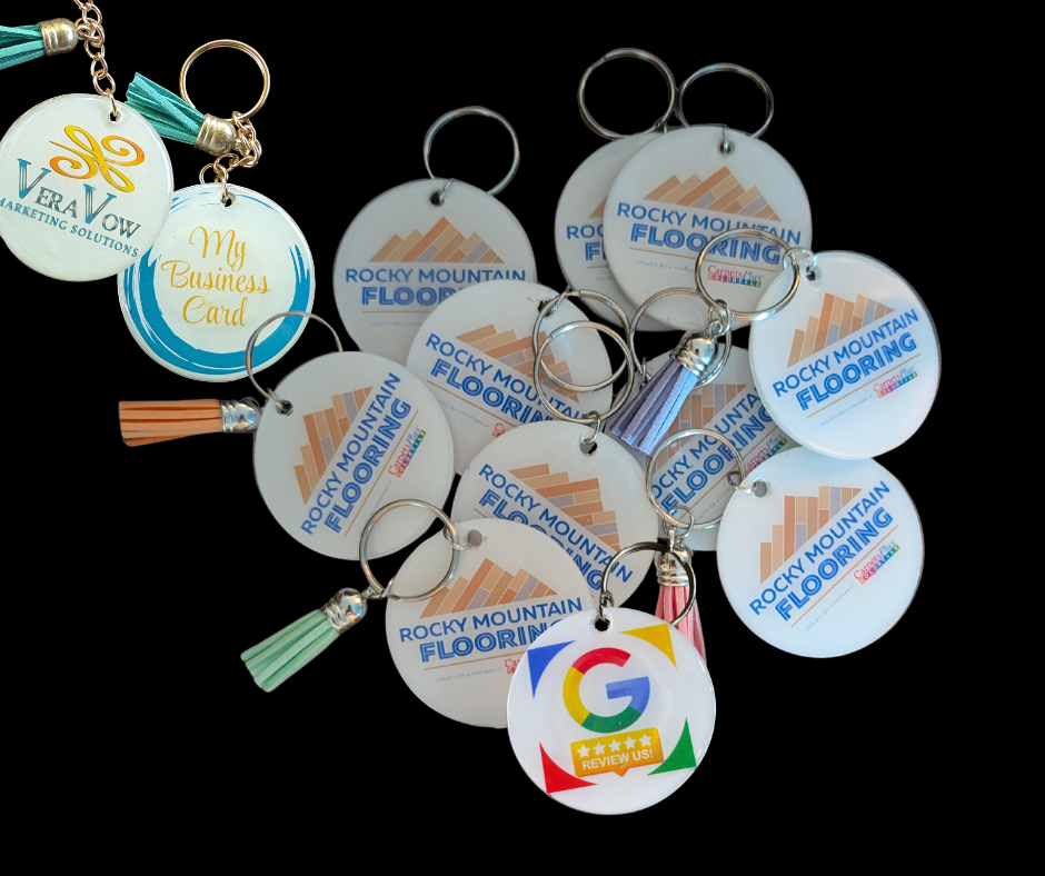 Keychains with company logos and tassels, including 