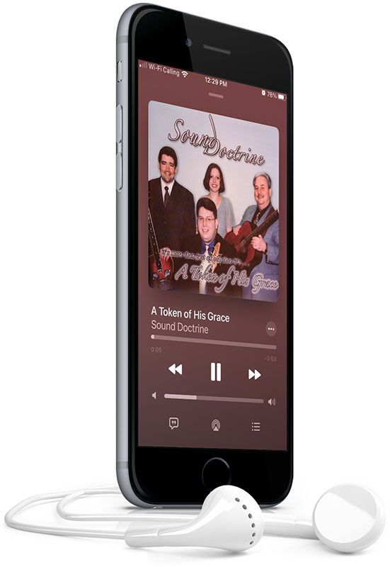 A cell phone with ear buds attached to it is playing a song.