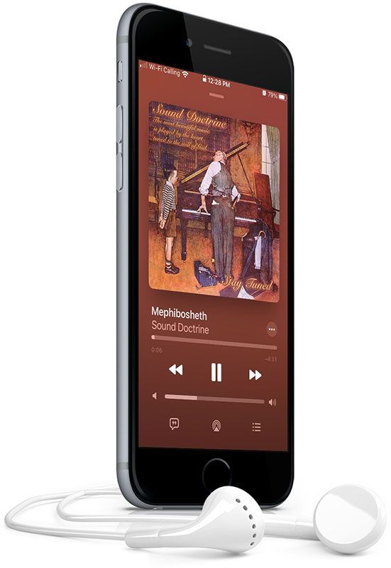 A cell phone with earbuds attached to it is playing a song.