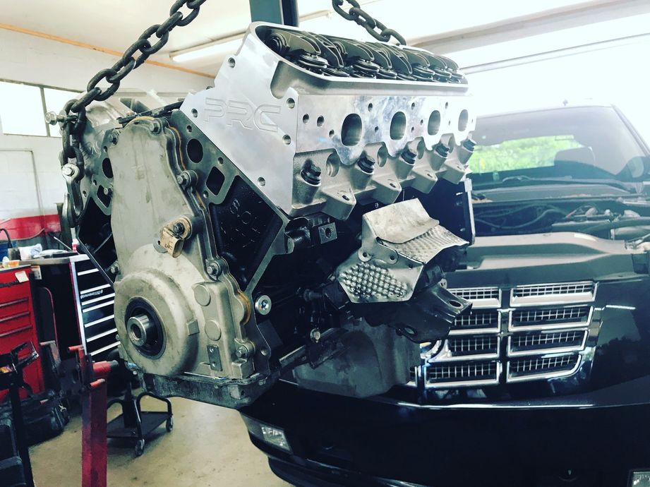A close up of a car engine with gears and pulleys
