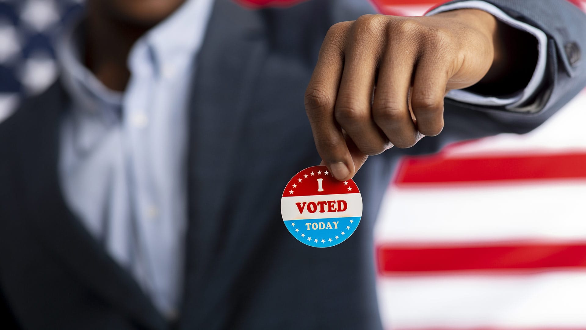 person holding I voted sticker