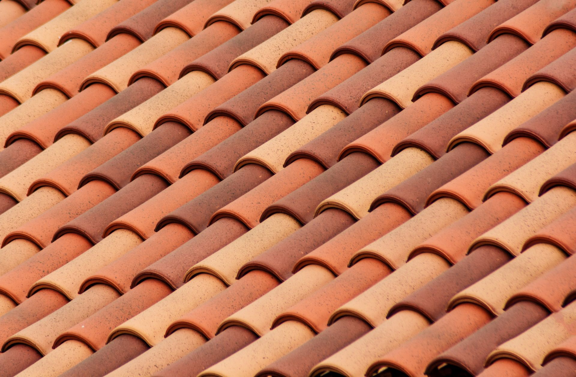 Rows of terracotta roof tiles in a repeating curved pattern