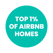 Teal badge with white text: “TOP 1% OF AIRBNB HOMES”