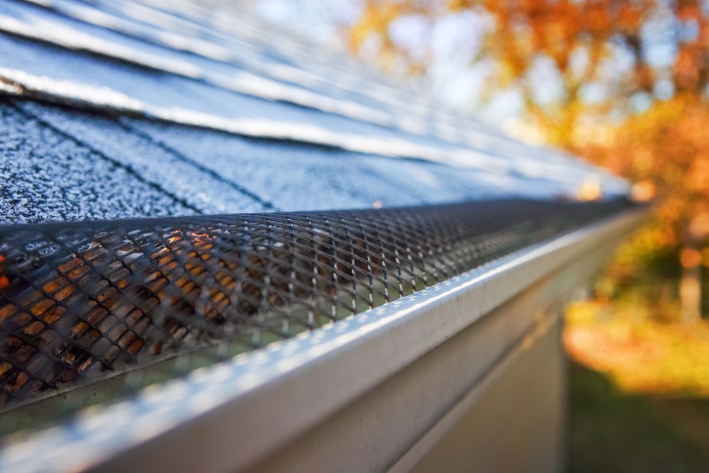 A Close Up Of A Gutter With A Roof In The Background — Roof & Guttering Solutions In Saratoga, NSW