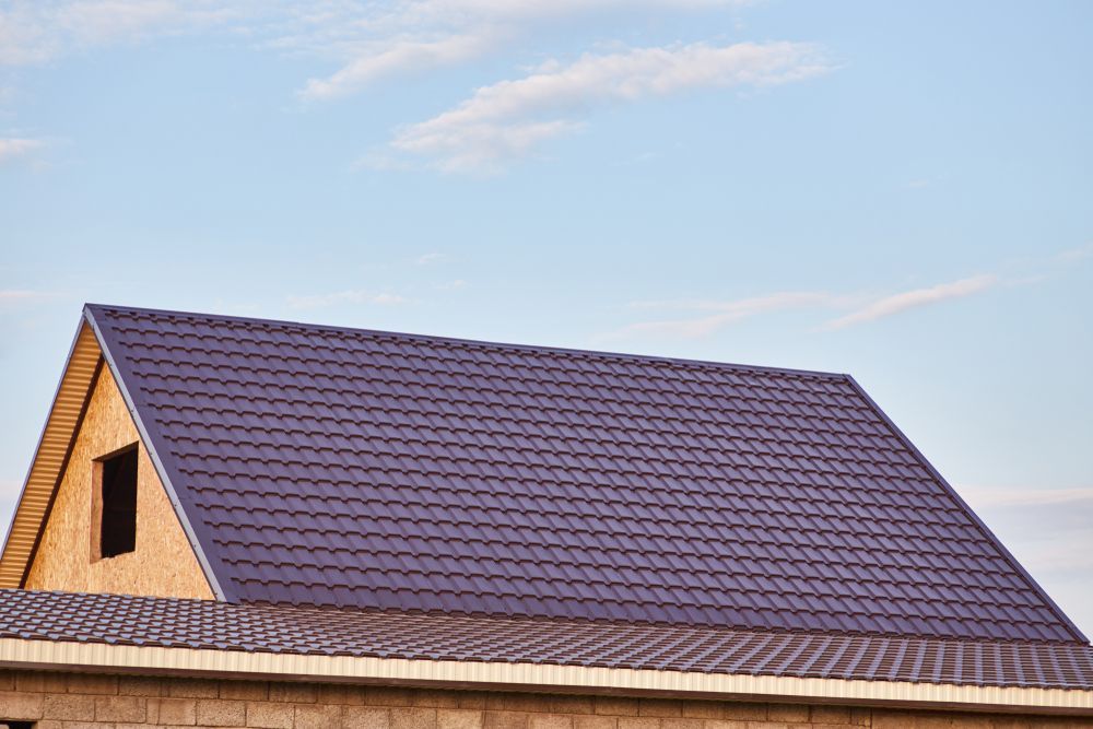 A House Under Construction With A Purple Roof And A Window — Roof & Guttering Solutions In Saratoga, NSW