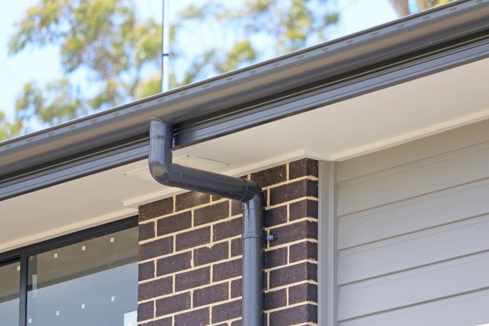 A Close Up Of A Gutter On The Side Of A House — Roof & Guttering Solutions In Gosford, NSW