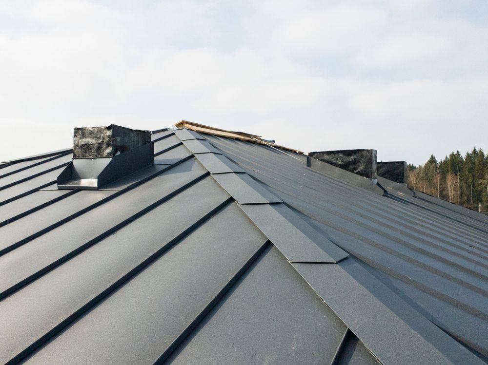 A Close Up Of A Roof With A Chimney On It — Roof & Guttering Solutions In Woy Woy, NSW