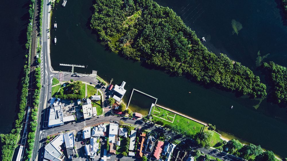 An Aerial View Of A Small Island In The Middle Of A River Surrounded By Trees — Roof & Guttering Solutions In Woy Woy, NSW