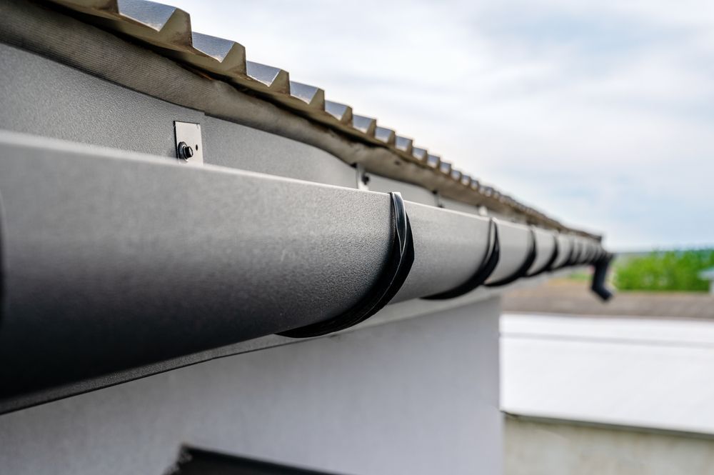 A Close Up Of A Gutter On The Roof Of A Building — Roof & Guttering Solutions In Saratoga, NSW