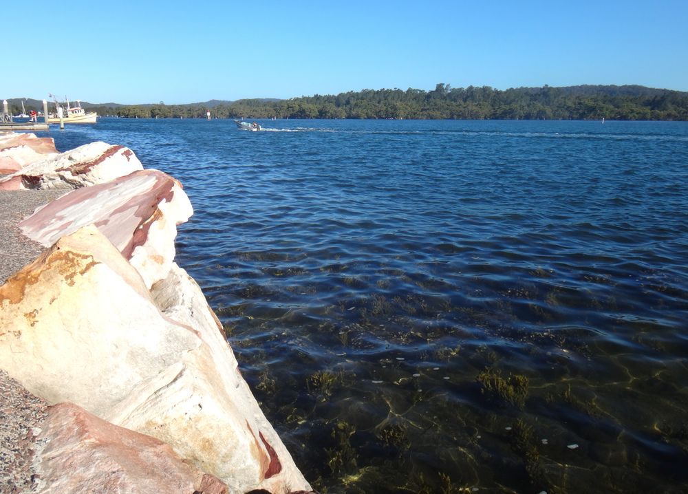 A Large Body Of Water With A Boat In The Distance — Roof & Guttering Solutions In Saratoga, NSW