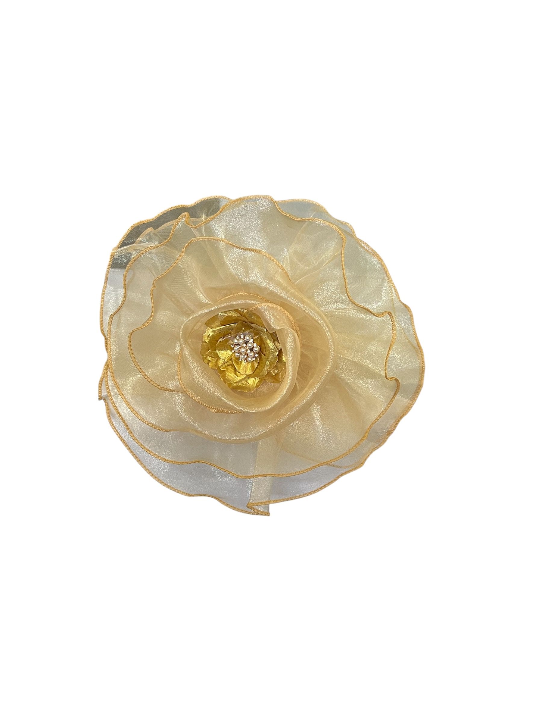 White flower with layered petals and a gold center on a plain background