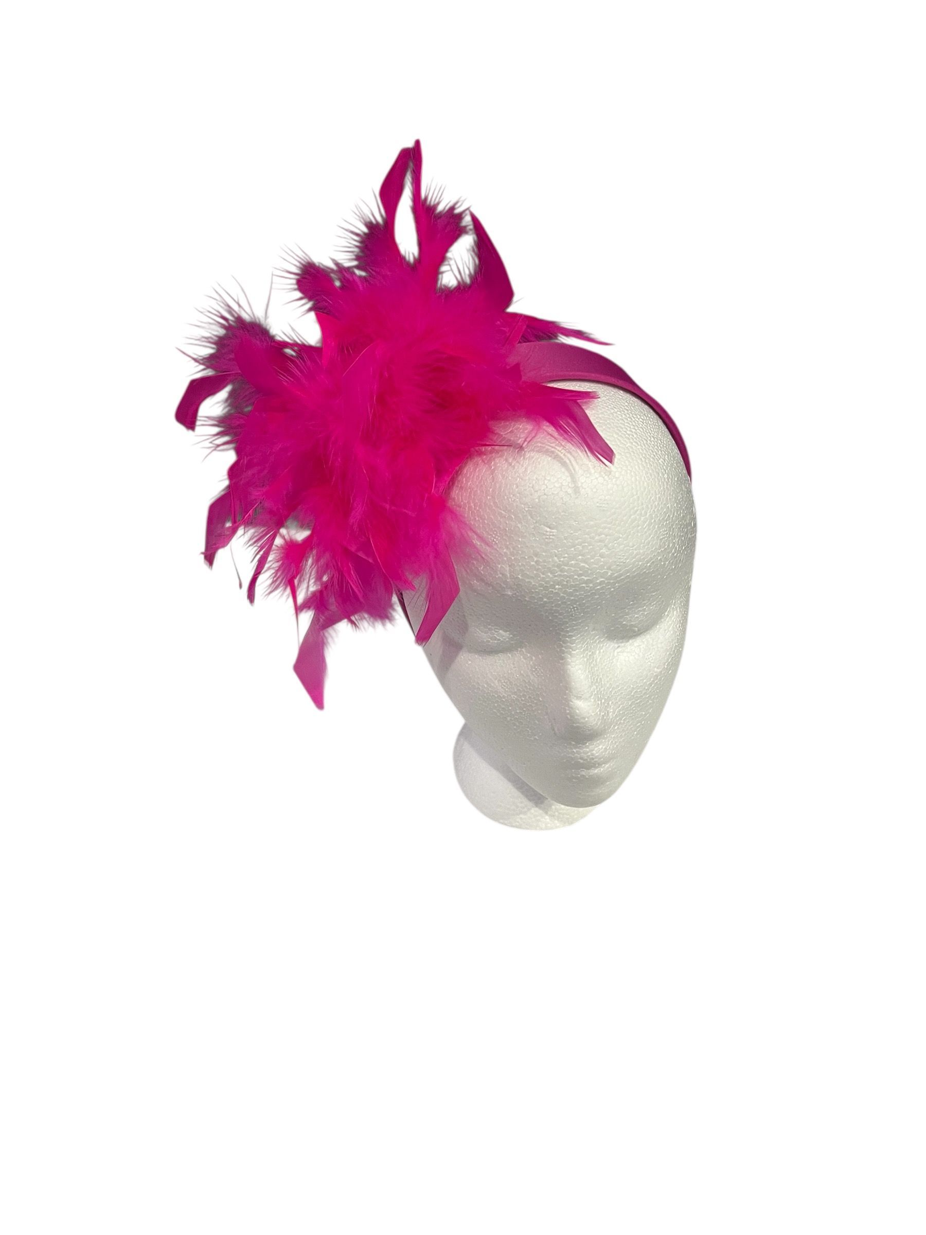 Silver mask with bright pink feathers on top and side