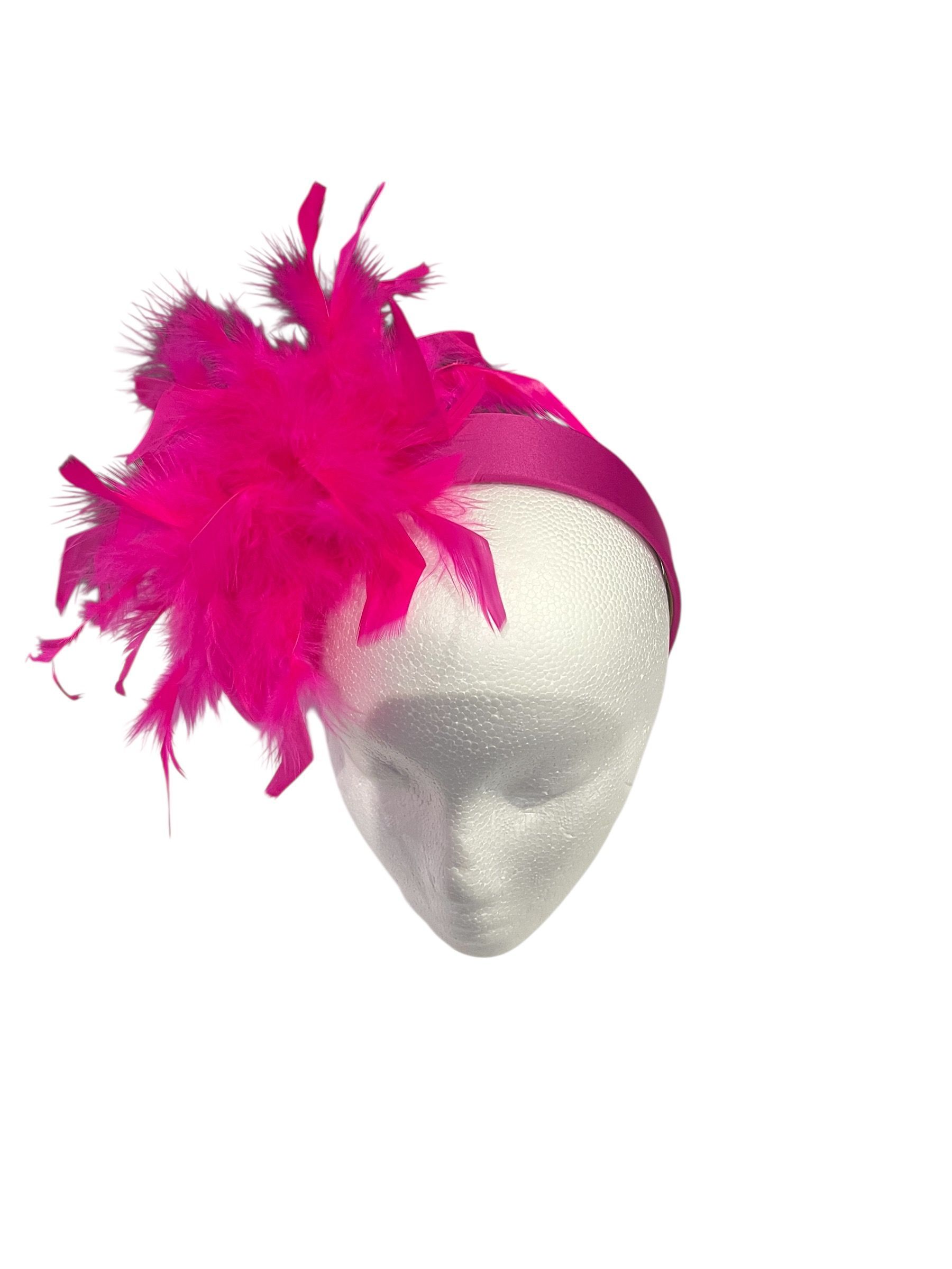 Silver mask with bright pink feathers on top and side