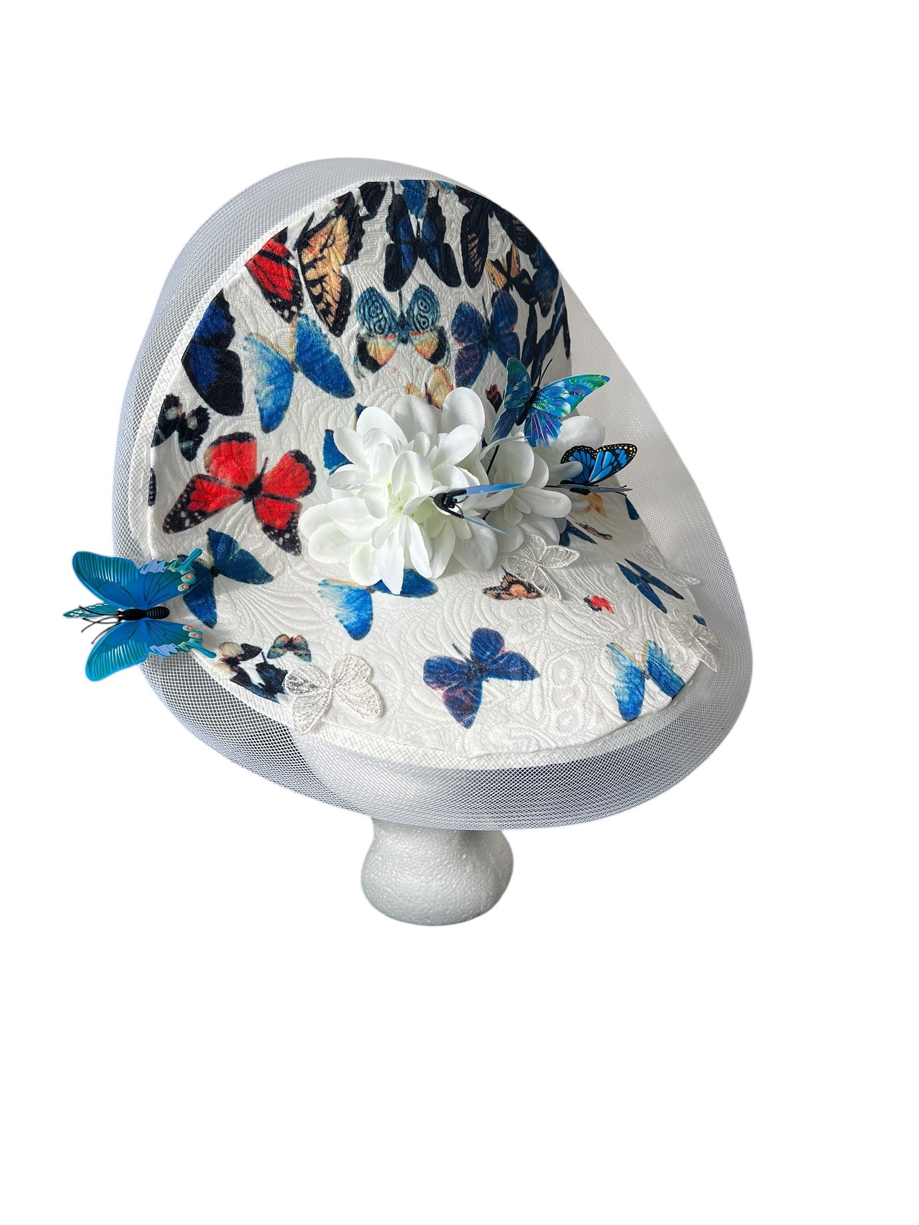Decorative white chair with blue and red butterfly pattern and white floral embellishments