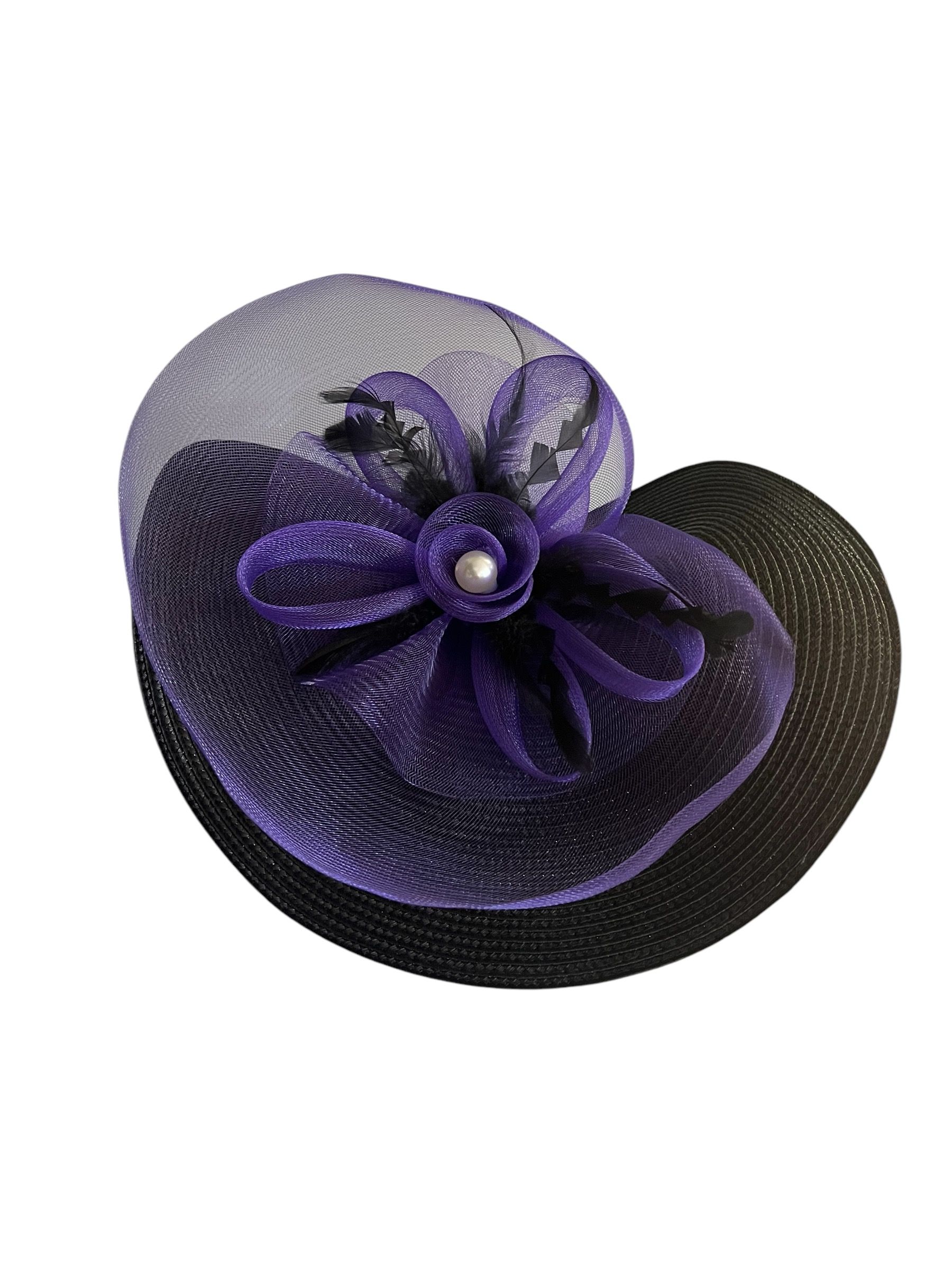 Purple wide-brim hat with a floral decoration and black netting on a white background