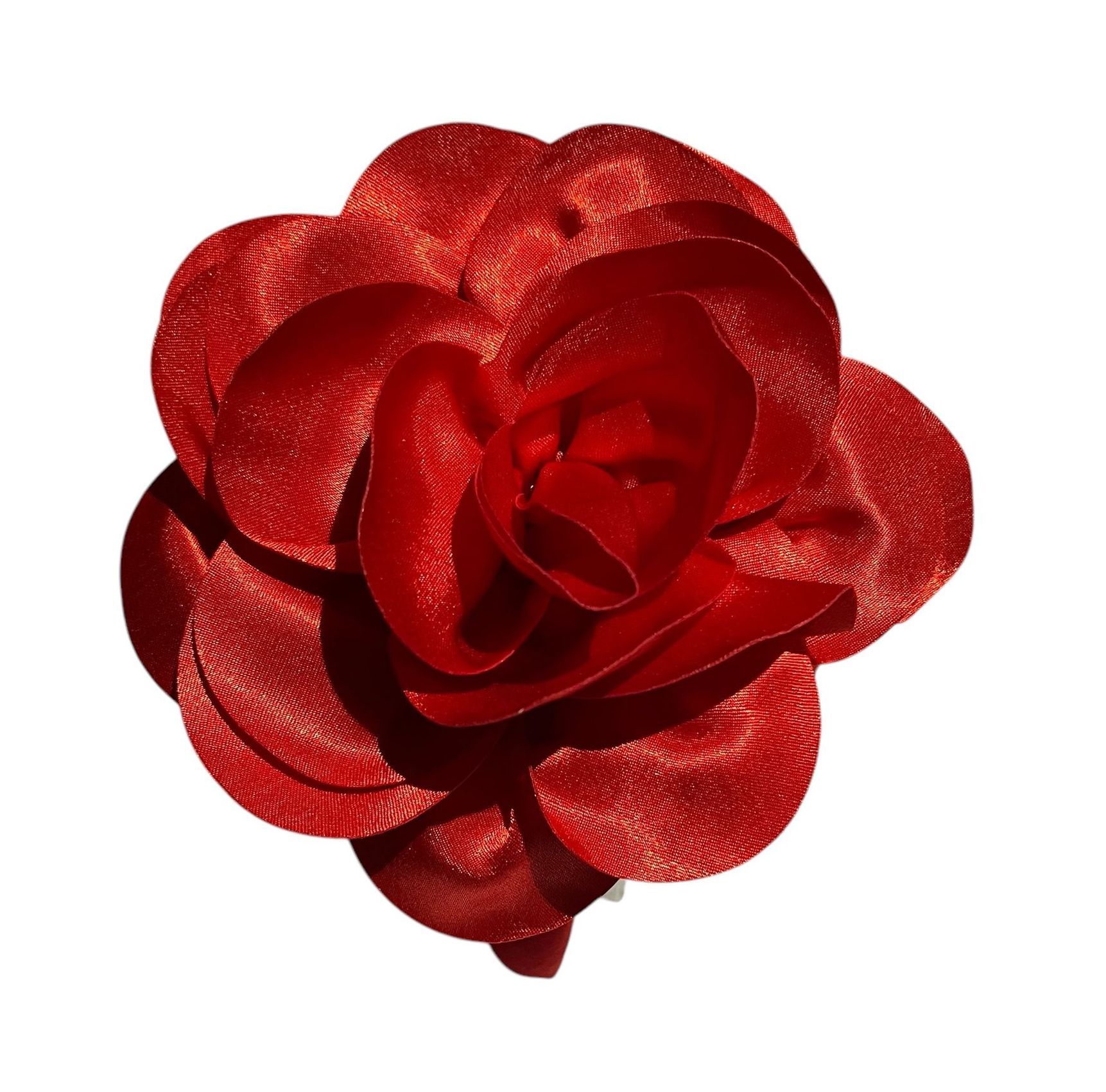 Red rose made of shiny ribbon on a white background