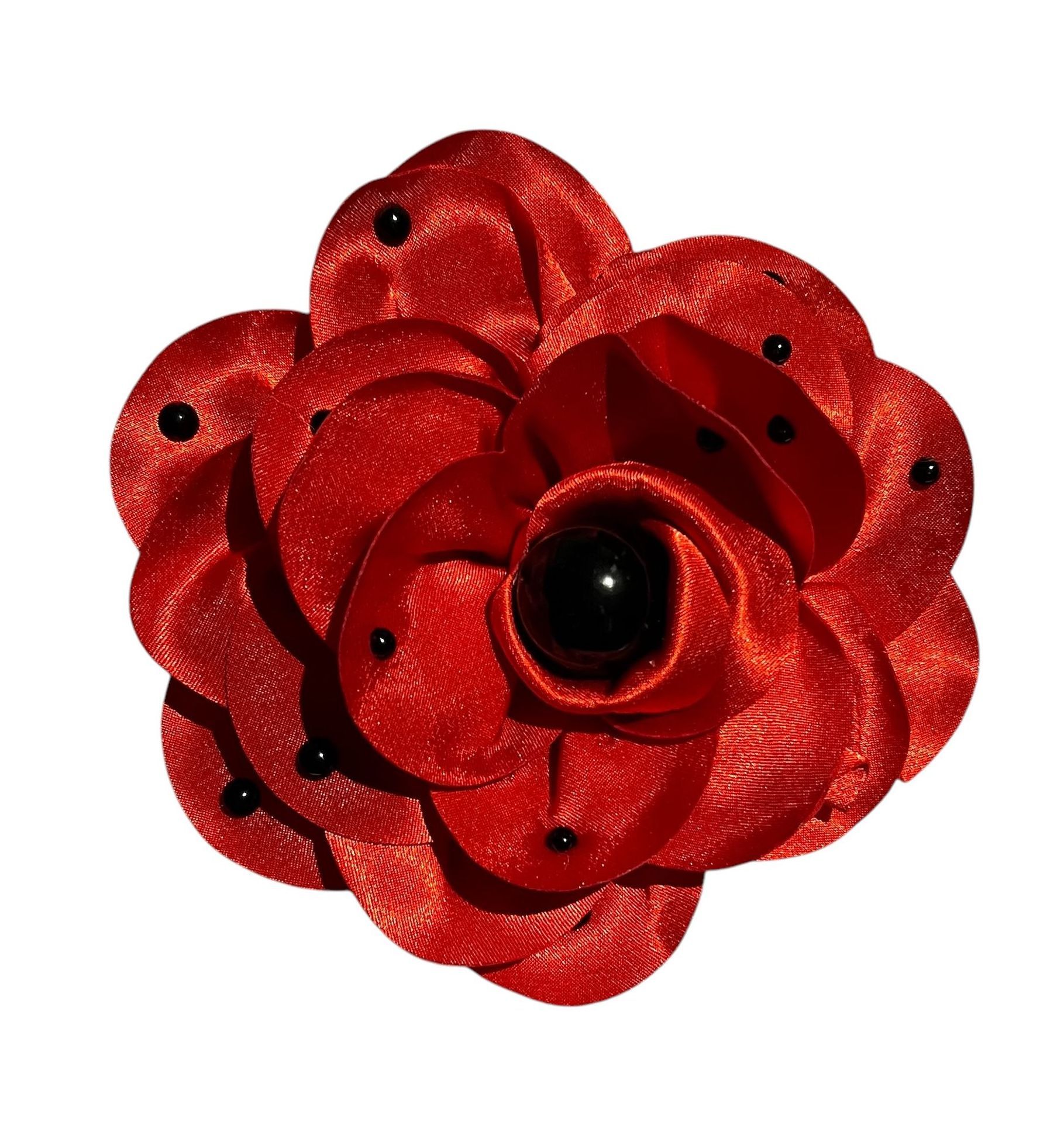 Red fabric flower with black sequins and a dark center on a white background