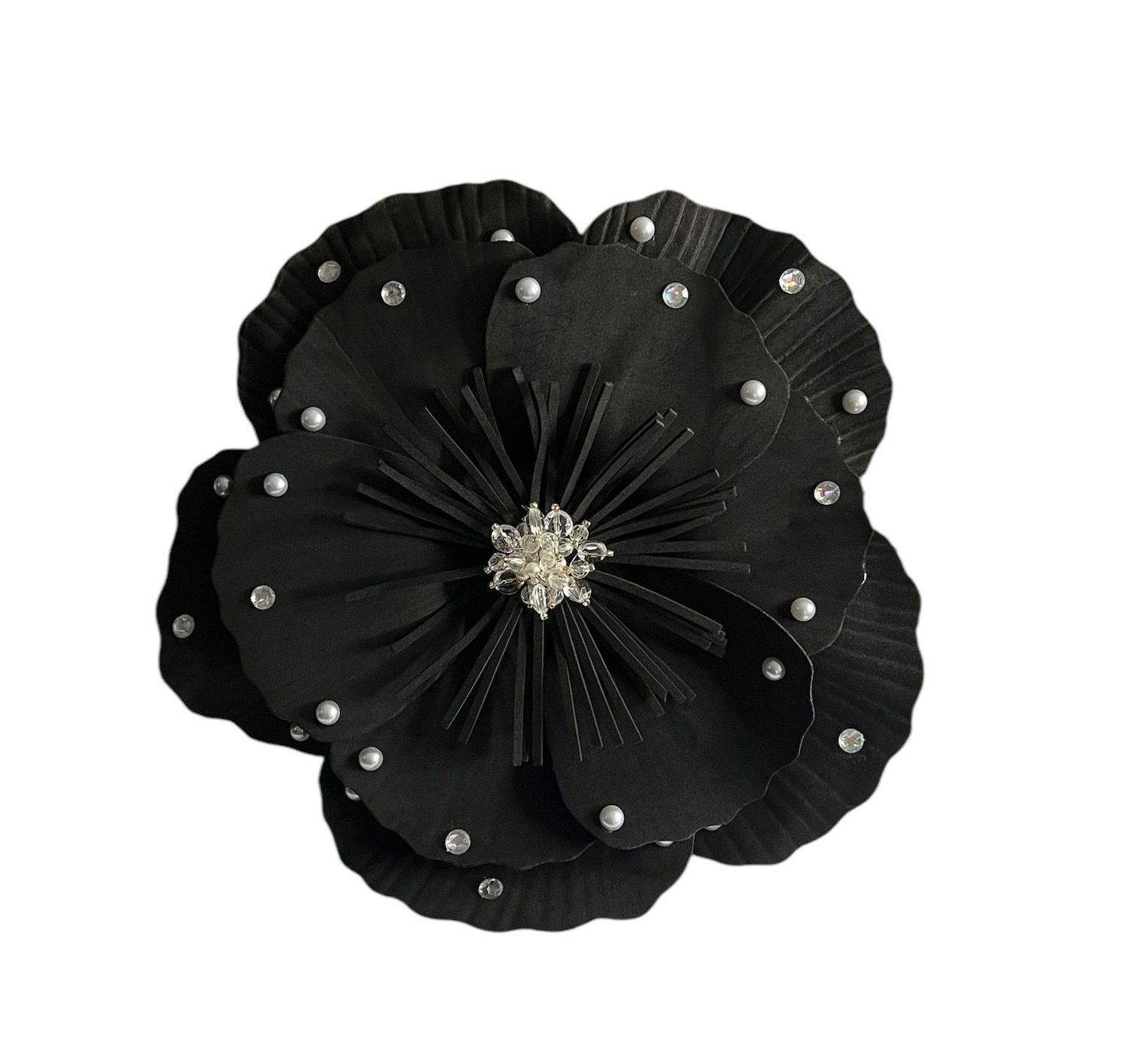 Black fabric flower brooch with silver studs and a jeweled center