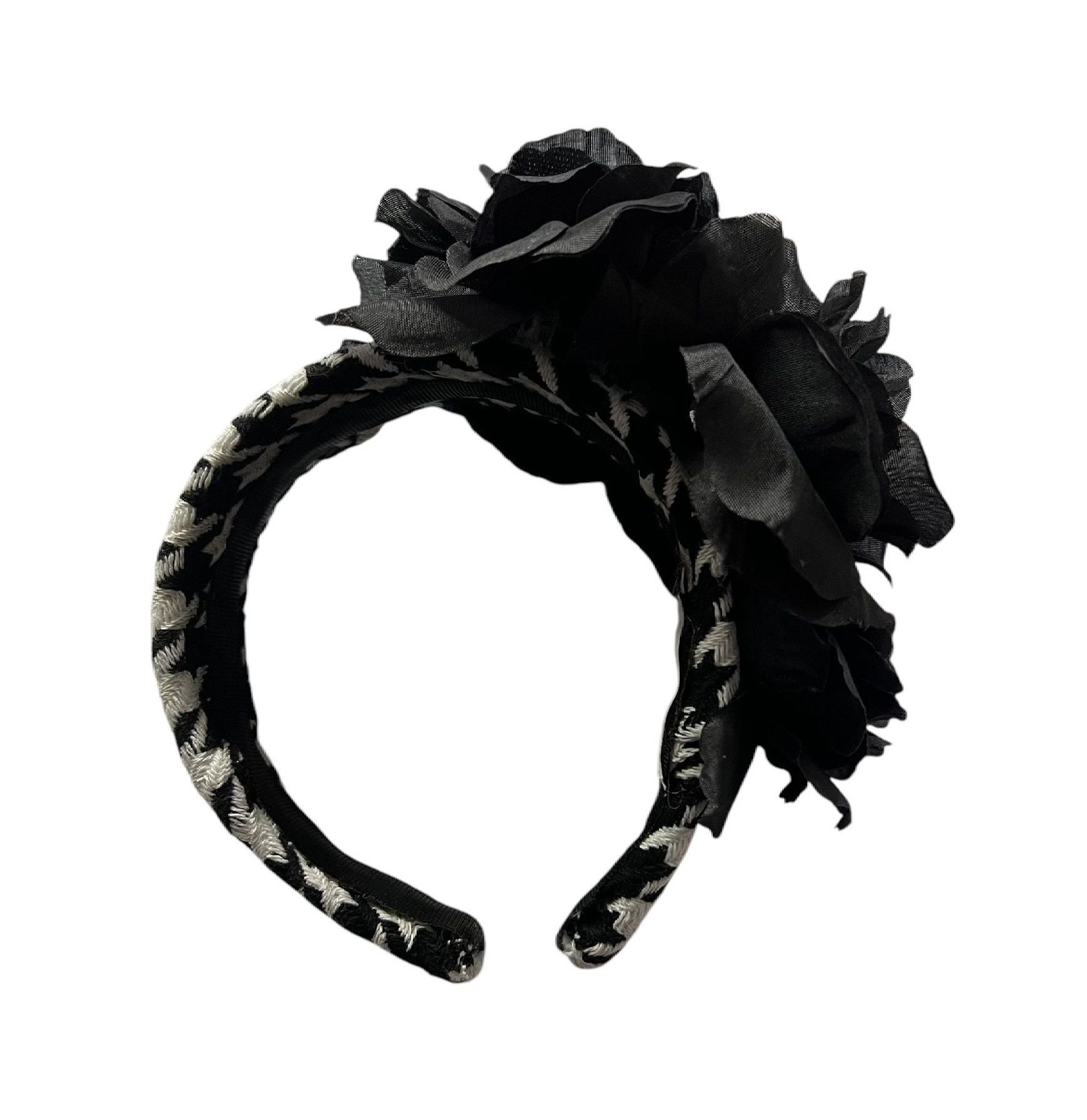 Black textured decorative floral arrangement on a white background