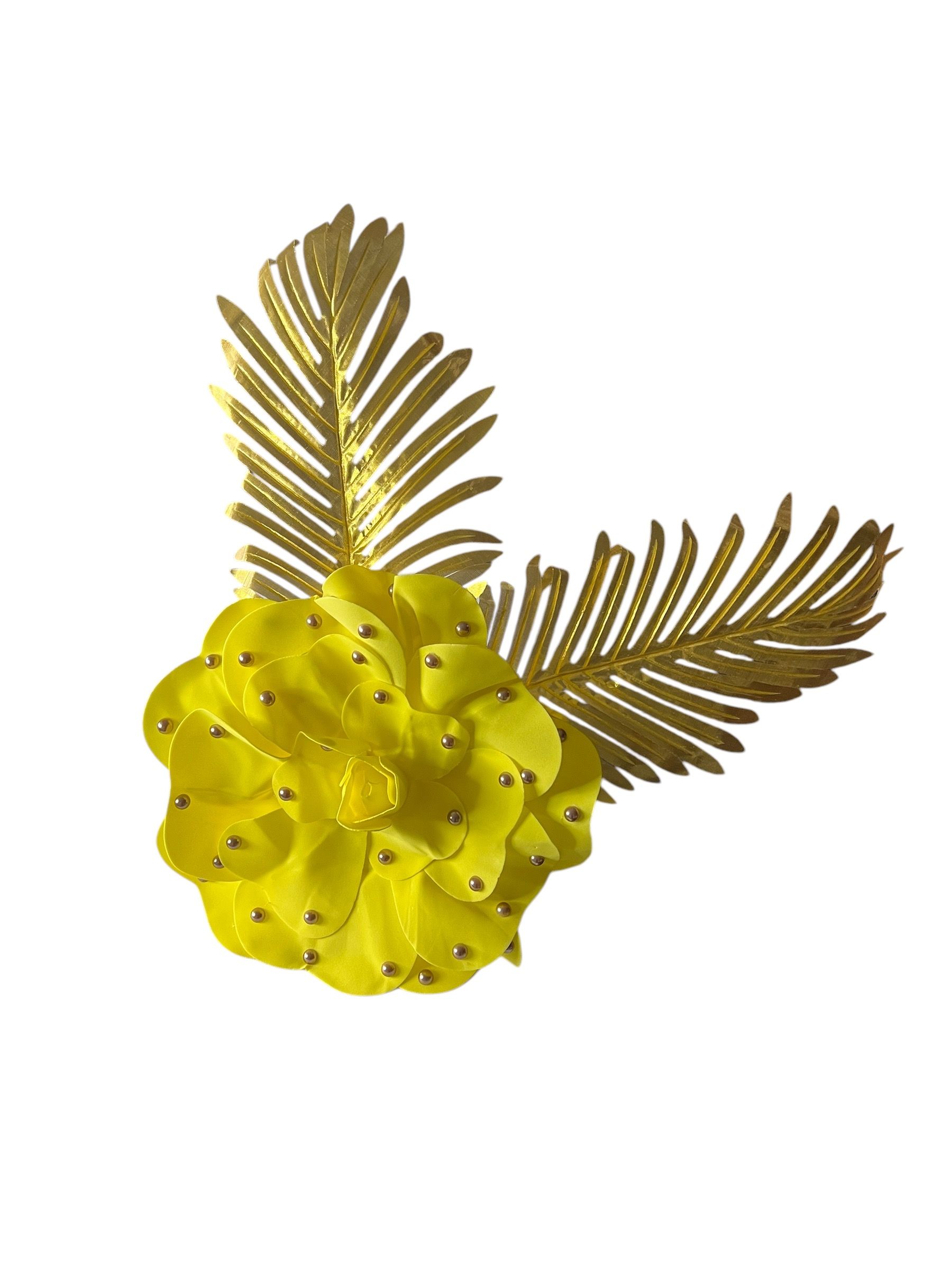 Gold floral brooch with two textured leaves on a white background