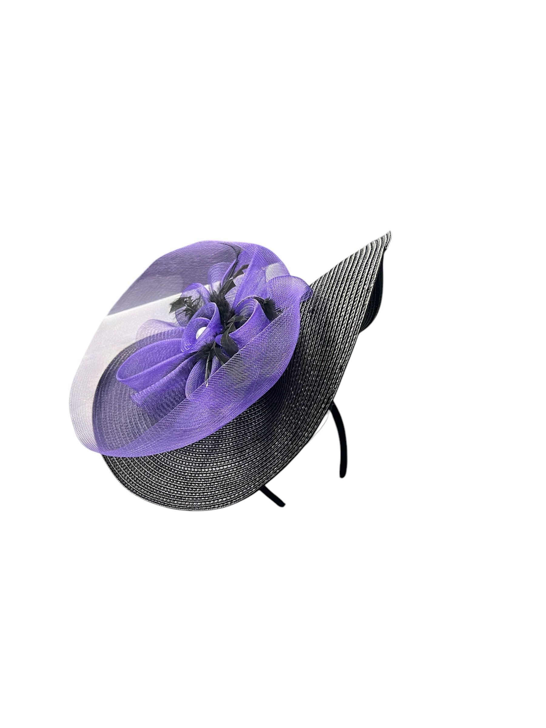 Purple wide-brim hat with a floral decoration and black netting on a white background