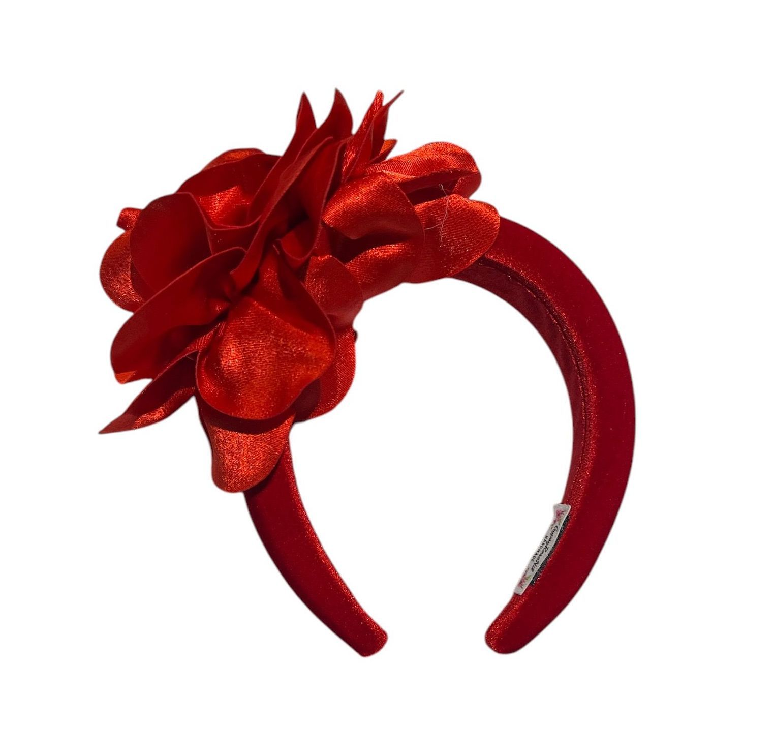 Red rose made of shiny ribbon on a white background