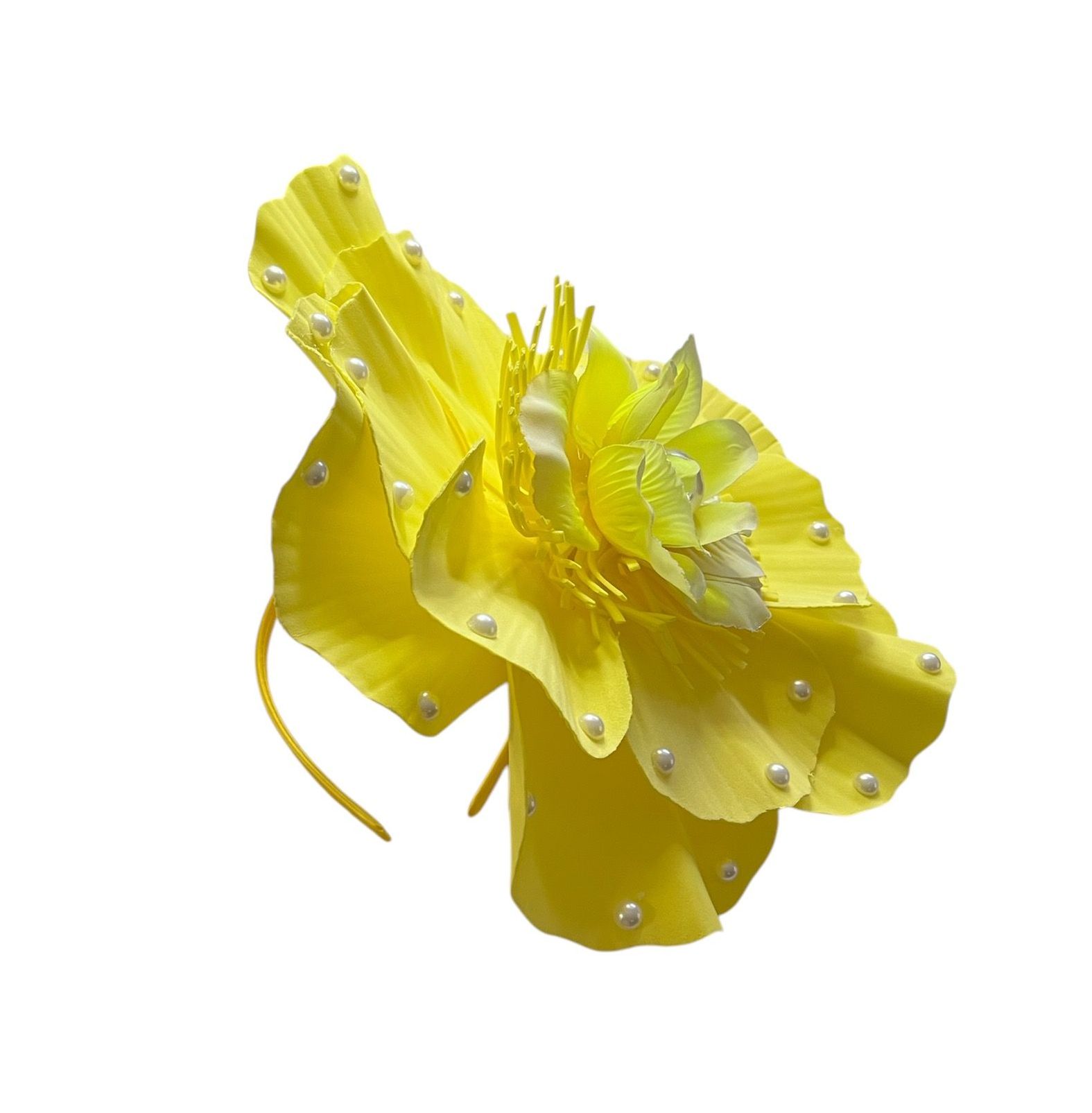 Yellow flower with layered petals and small pearl-like accents on a white background