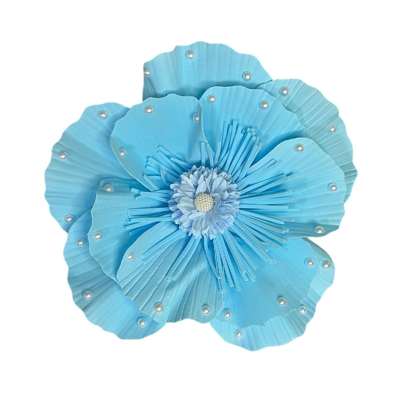 Blue flower with layered petals and beaded center on a white background