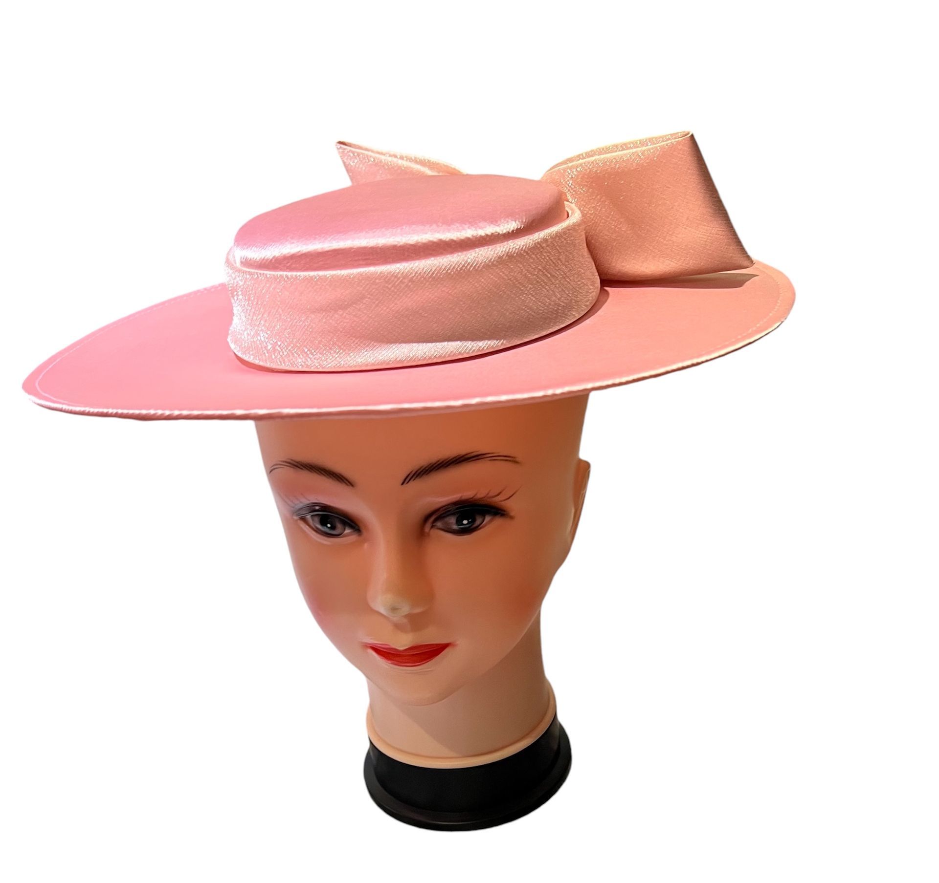 Pink glittery wide-brim hat with a round crown and feather accent