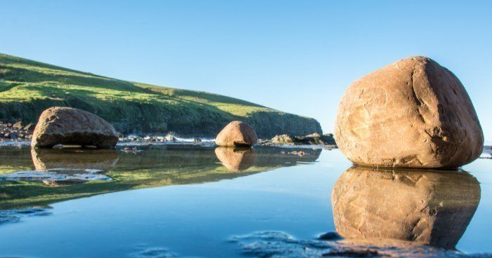 Two Large Rocks Are Sitting In The Middle Of A Lake — Sal's Excavations In Kiama, NSW