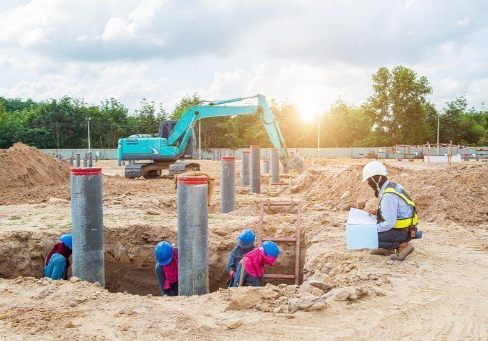A Group Of Construction Workers Are Working On A Construction Site — Sal's Excavations In Ulladulla, NSW