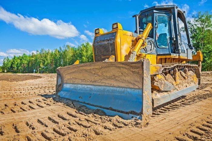 A Bulldozer Is Moving Dirt On A Construction Site — Sal's Excavations In Vincentia, NSW