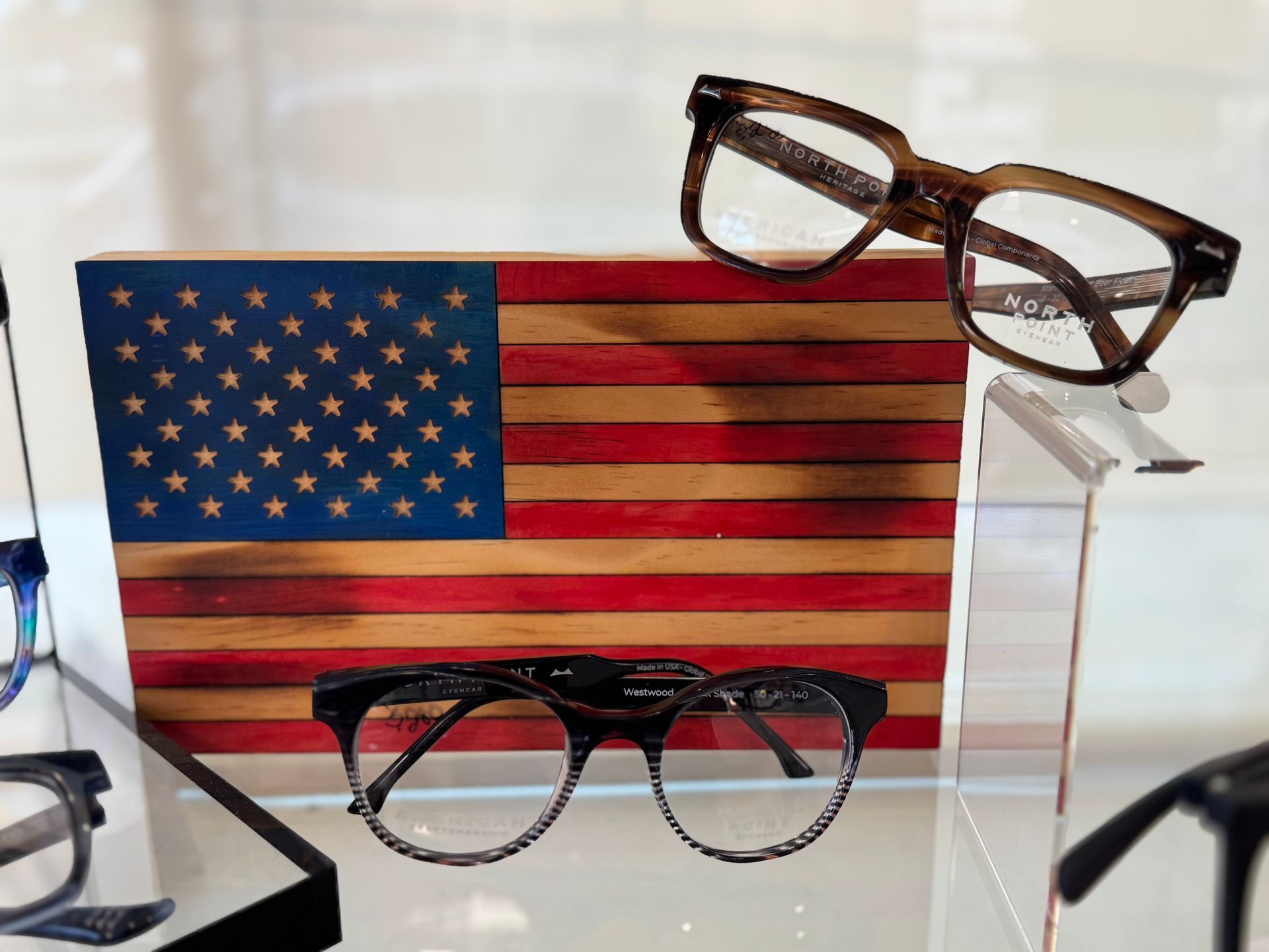 A pair of glasses sitting on top of an american flag