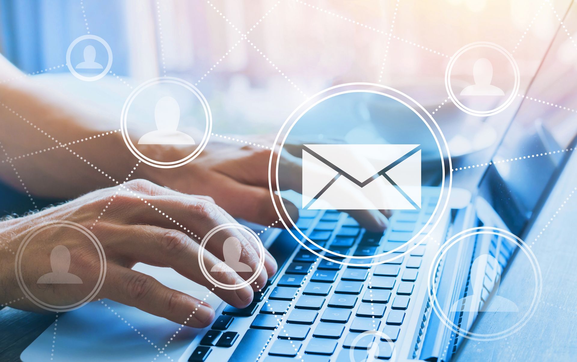 A person is typing on a laptop computer with an envelope coming out of it.