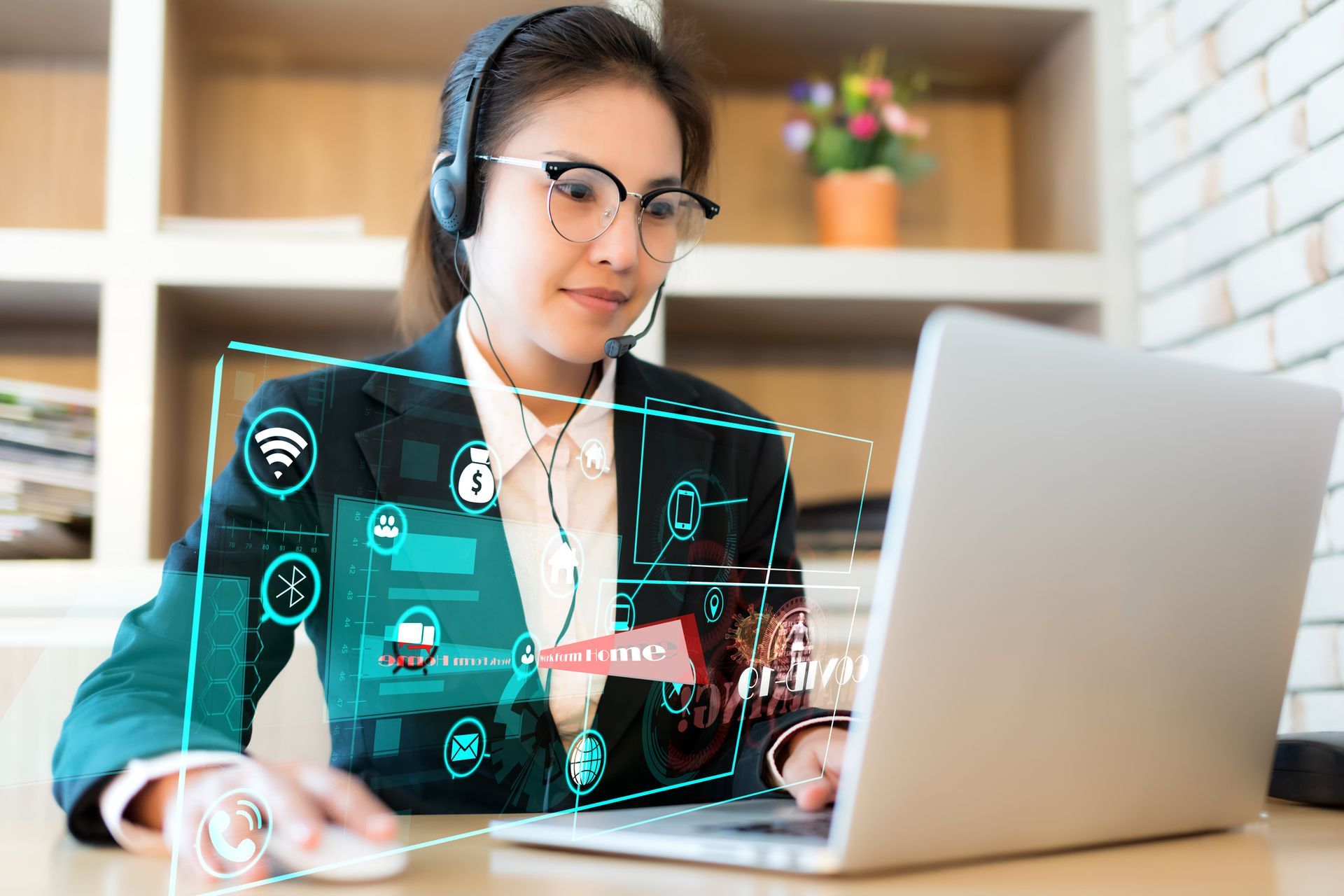 A woman wearing a headset is sitting in front of a computer.