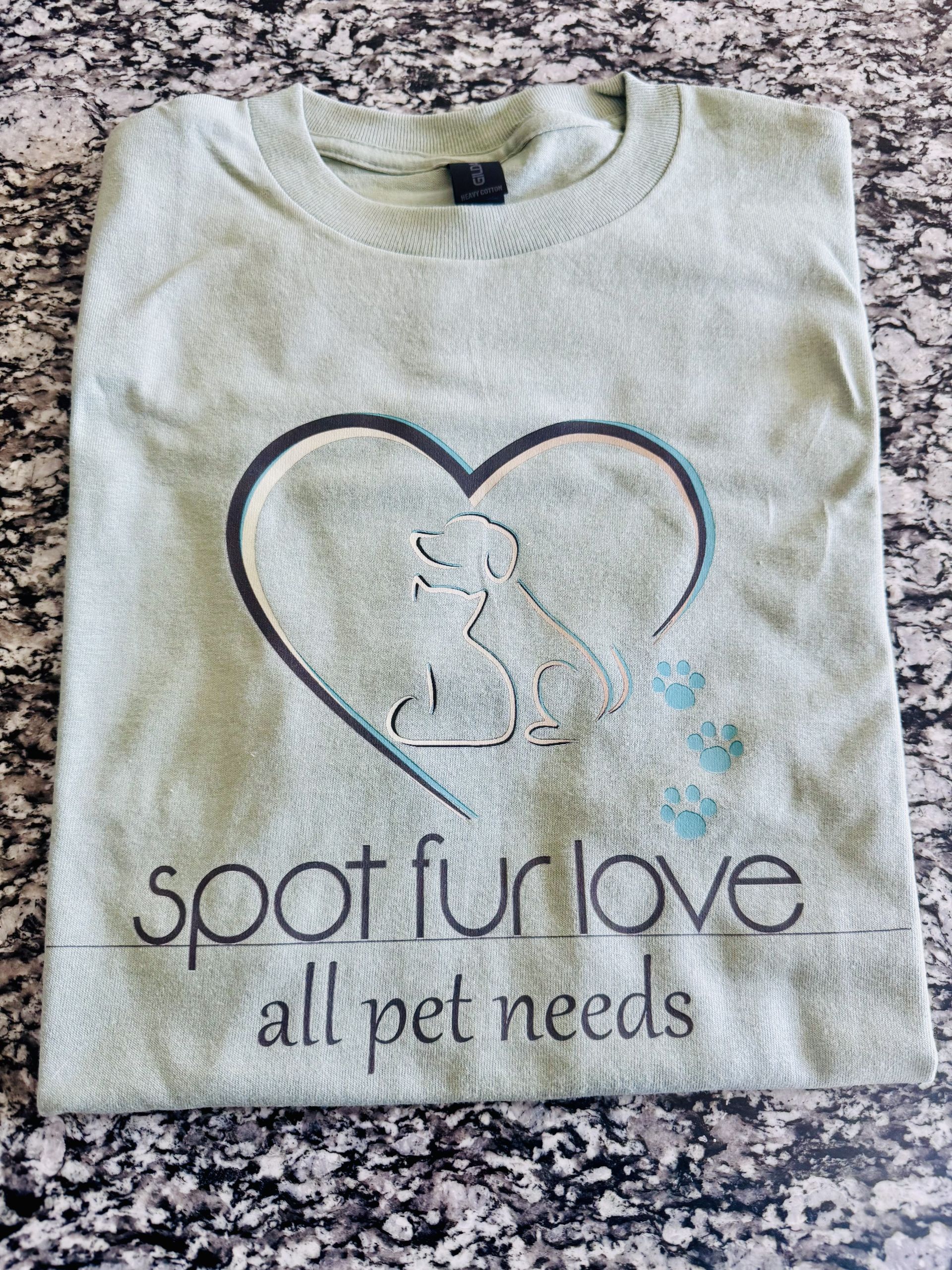 Green t-shirt with heart-shaped dog silhouette, paw prints, and text
