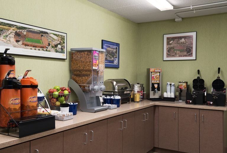 A kitchen with a lot of appliances and a picture on the wall.