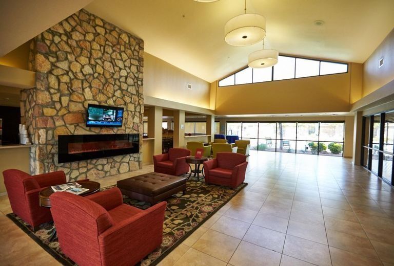 A hotel lobby with a fireplace and chairs