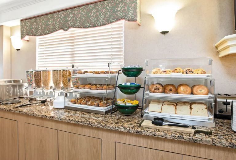 A hotel breakfast buffet with a variety of food on display.