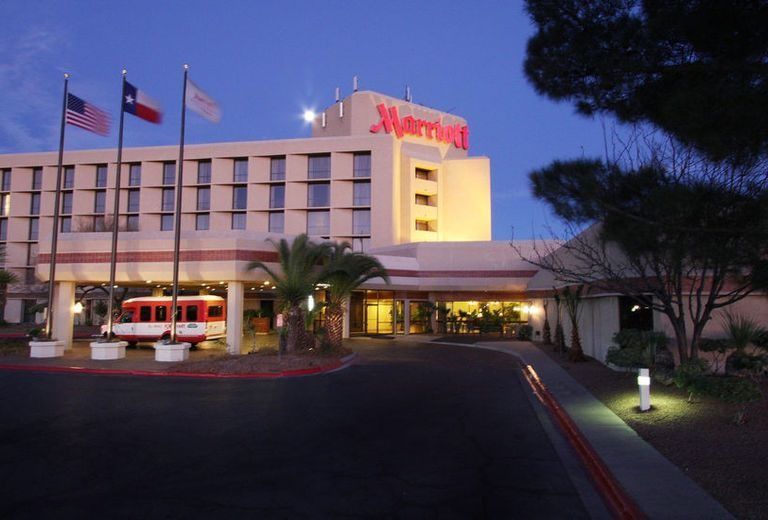 A large marriott hotel is lit up at night