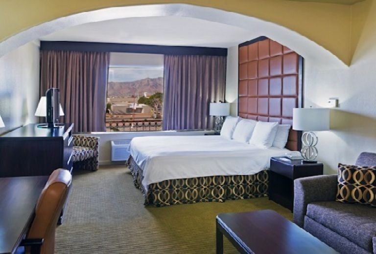 A hotel room with a large bed and a couch