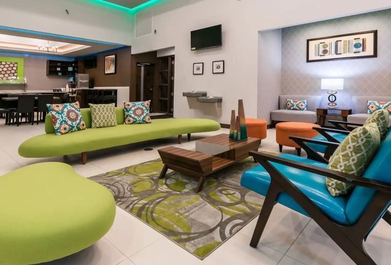 A living room with a green couch and blue chairs