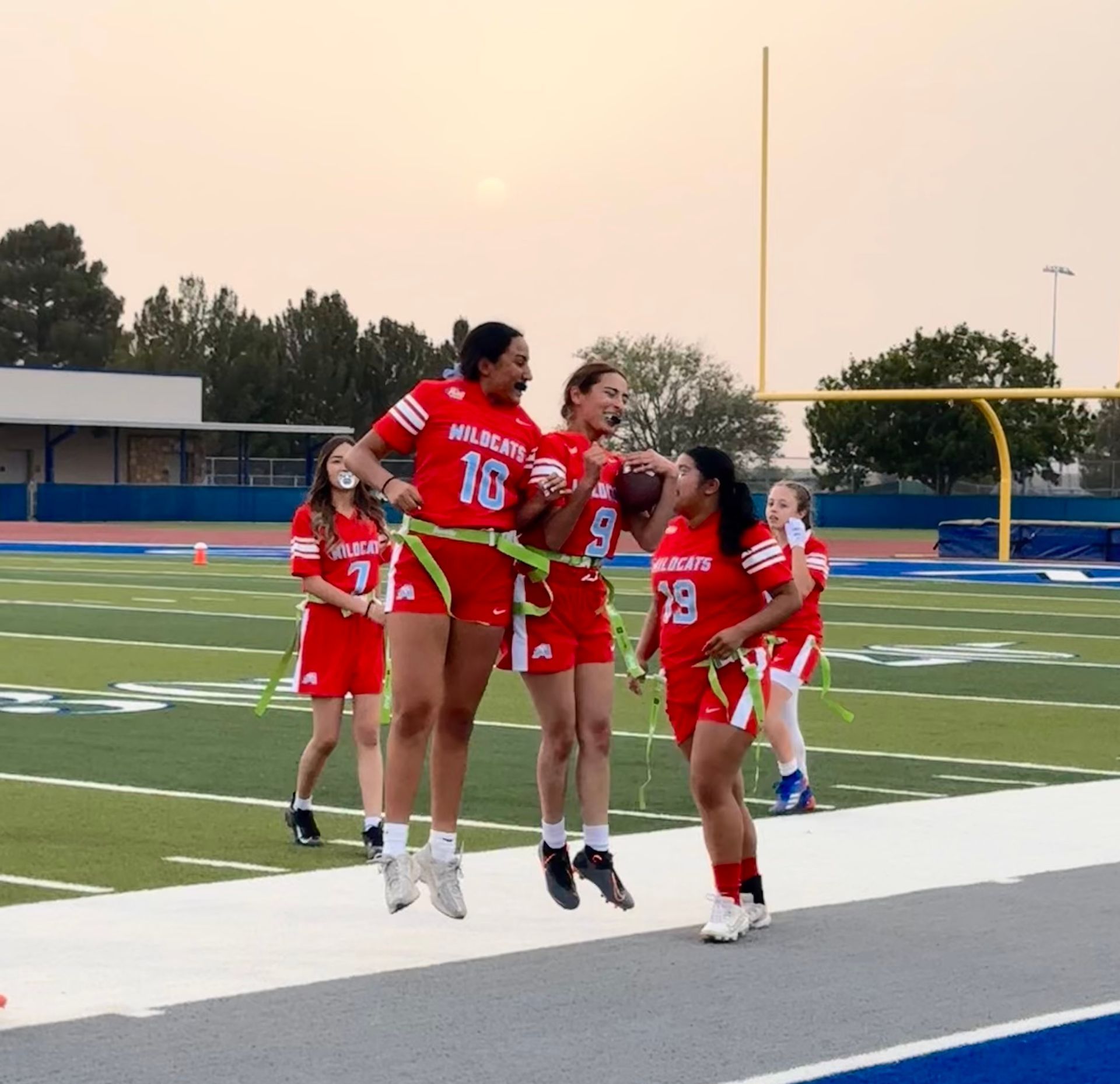 A group of girls wearing red uniforms with the number 16 on them