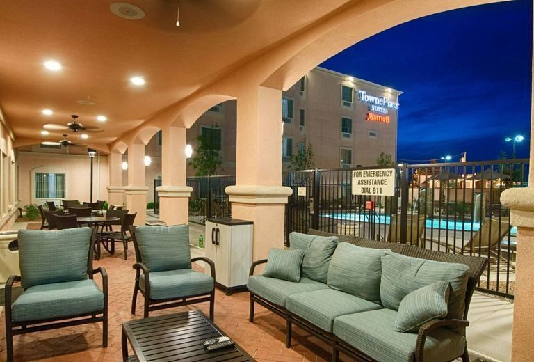 A patio with a couch , chairs and a table
