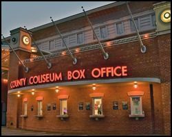 The county coliseum box office is located on the side of a brick building.
