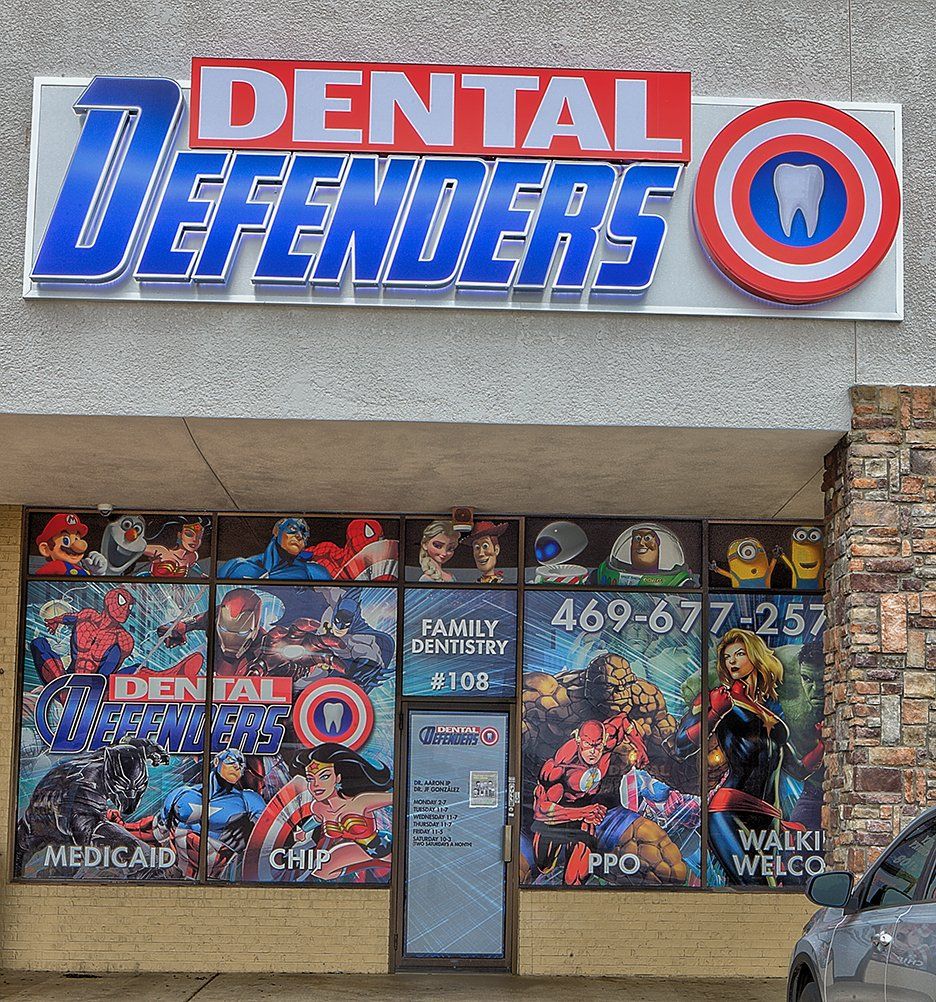Dental Defenders storefront with blue-red sign, masked cartoon window graphics, and glass entrance.