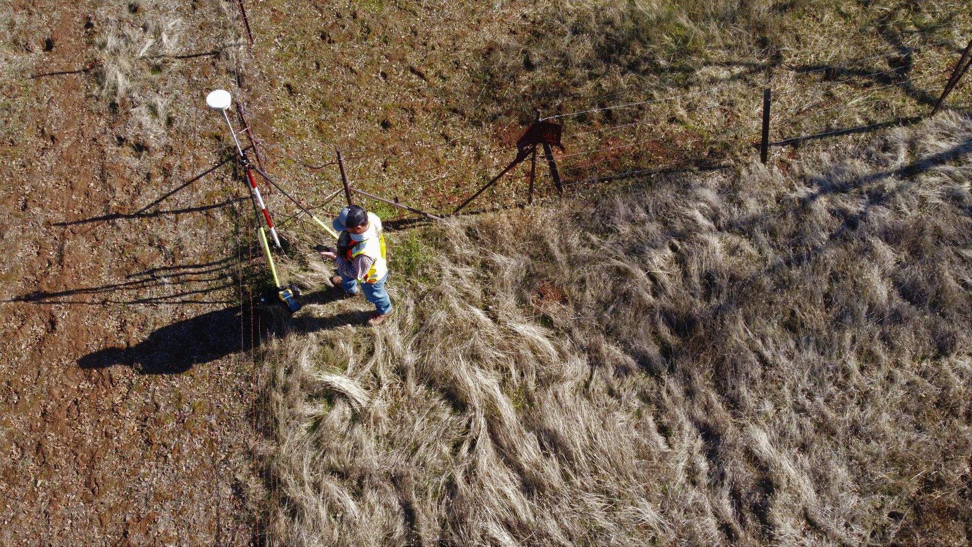 gps receiver in large open field next to fence line