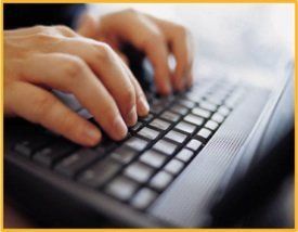 Hands typing on a laptop keyboard, drafting content marketing blog posts that people want to read and share