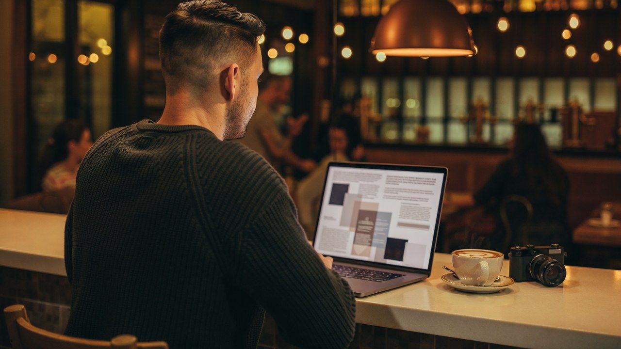 A man at his laptop reviewing the benefits of integration over time.
