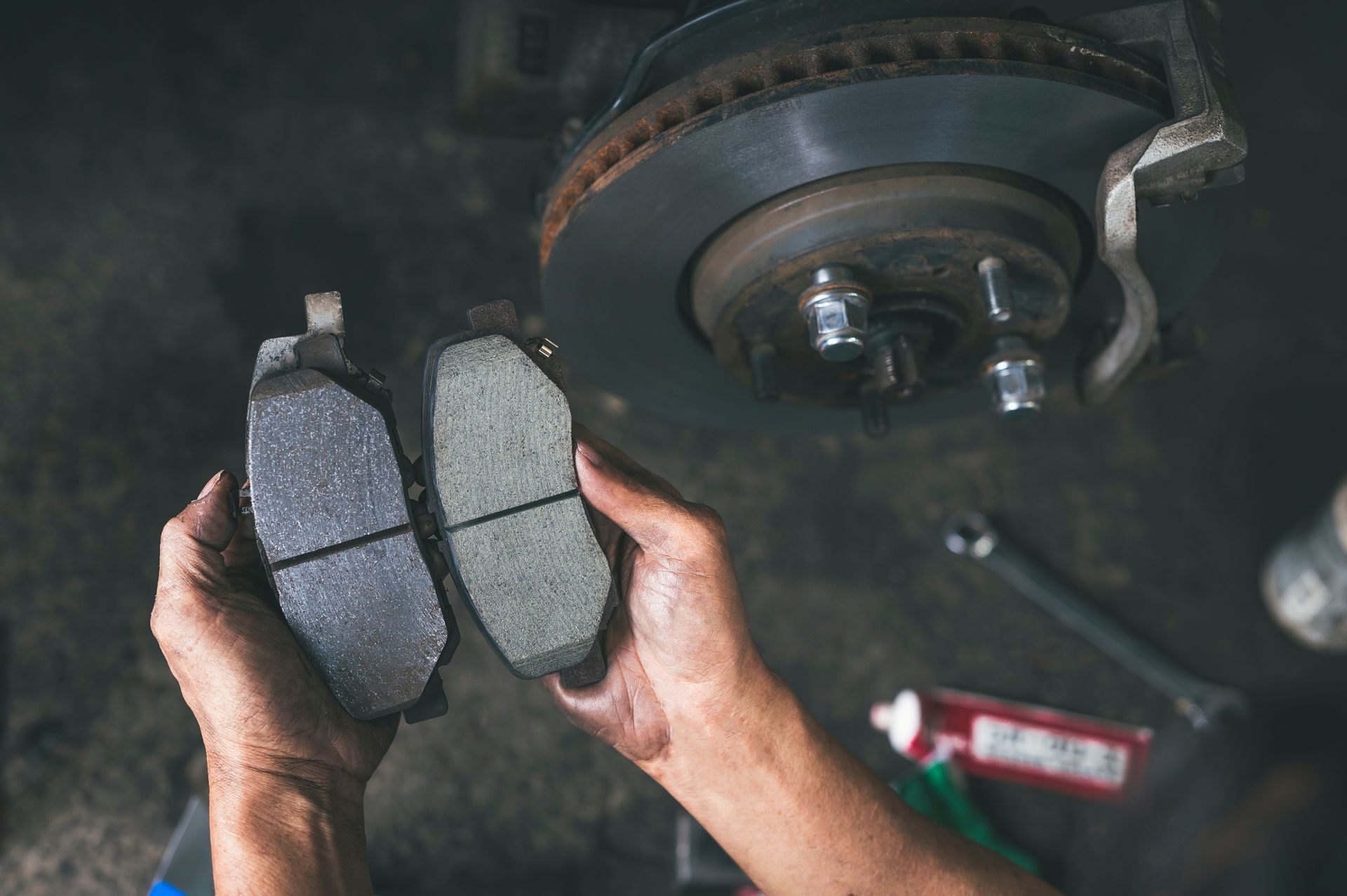 Mechanic Holding A New, Thick Brake Pad — Kings Brake Service Specialists in Tamworth, NSW